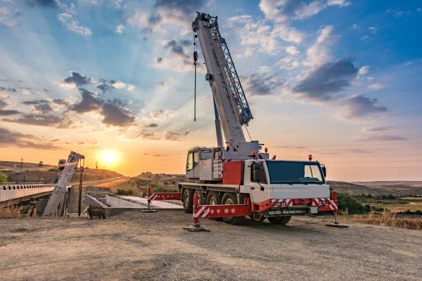 Crane trucks in the construction of a bridge Sunset building a highway bridge mobile crane stock pictures, royalty-free photos & images
