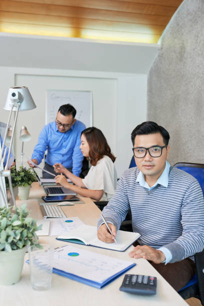 istock Casual man in office with colleagues 1028156902