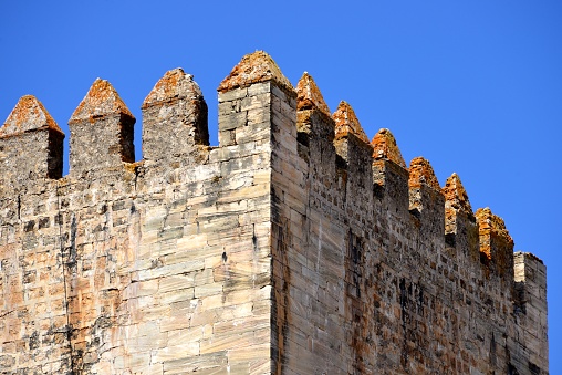 Moura, Beja district, Portugal: medieval tower battlement with crenellation - merlons and crenels on a crenellated parapet