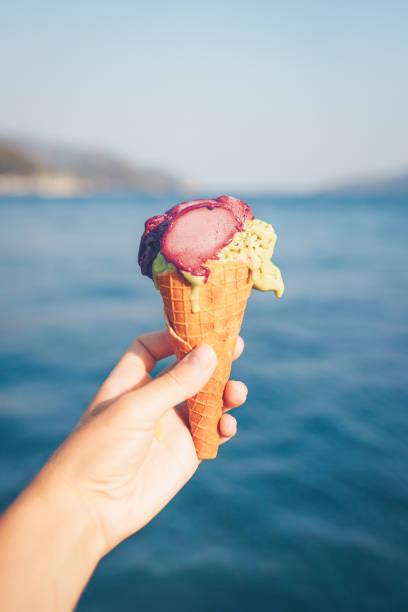 istock Woman's hand holding ice cream. 1028159330