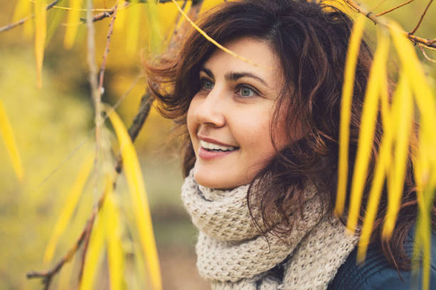 istock Autumn woman in fall park outdoors, portrait 1028160544