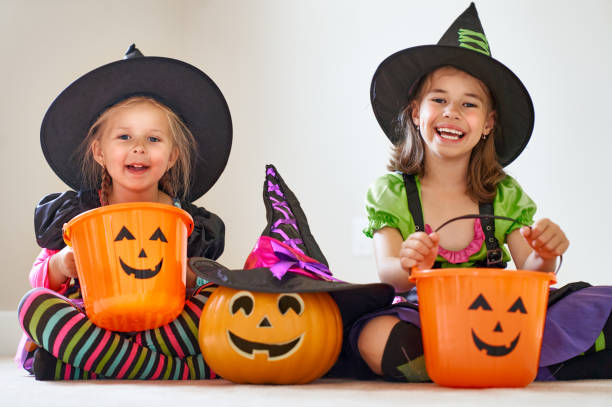 istock Laughing children in witches costumes. 1028161124