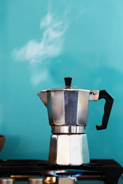istock Stove-top coffee pot steaming on gas ring 1028164524