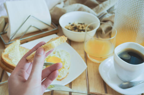 istock Morning breakfast on wooden tray in bed. Soft selective focus. 1028167872