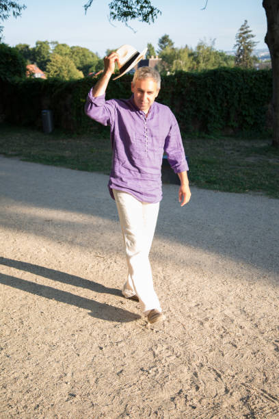 istock Happy man in straw hat walking near hedgerow 1028177690