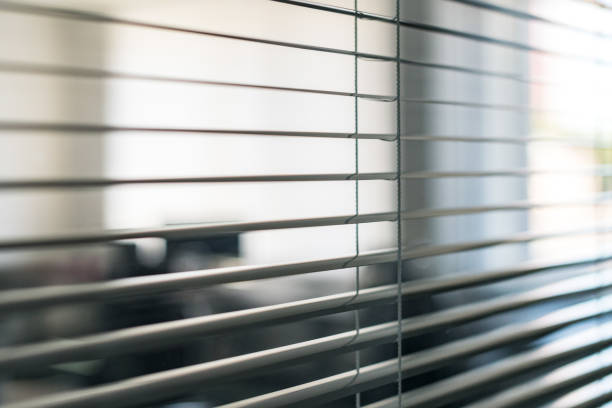 White blinds in front of open space office and workplace