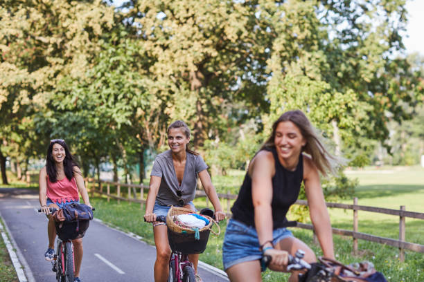 istock Three Young Women Riding Bicycles 1028184052