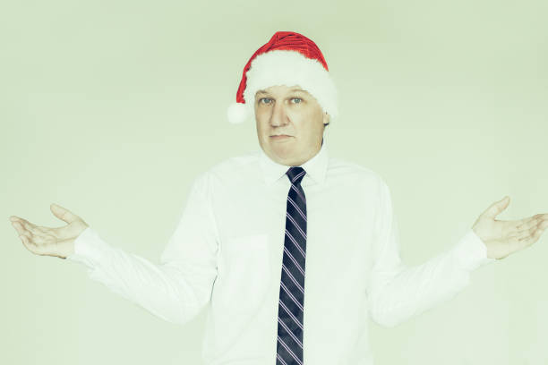 istock Doubtful Mature Business Man in Santa Hat 1028193734