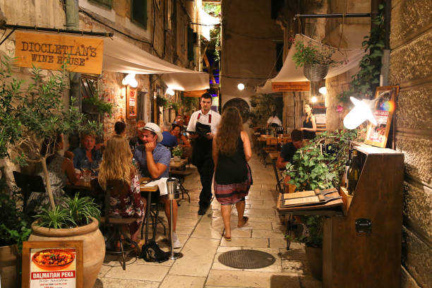 Croatia Nightlife Pedestrians and customers enjoying the restaurants and nightlife of Split in Croatia split croatia stock pictures, royalty-free photos & images