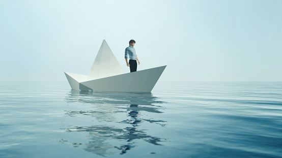 Young man navigate on paper boat - conceptual image. This is a 3d render illustration