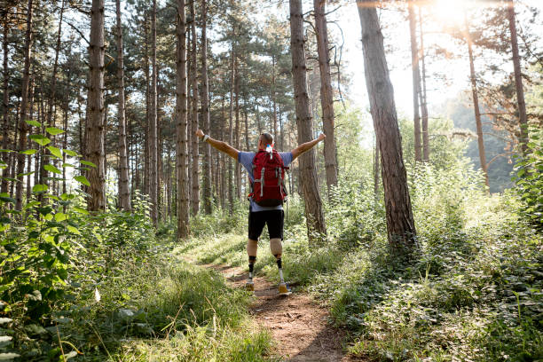 istock Hiker with artificial limbs arms raised in nature 1028203772