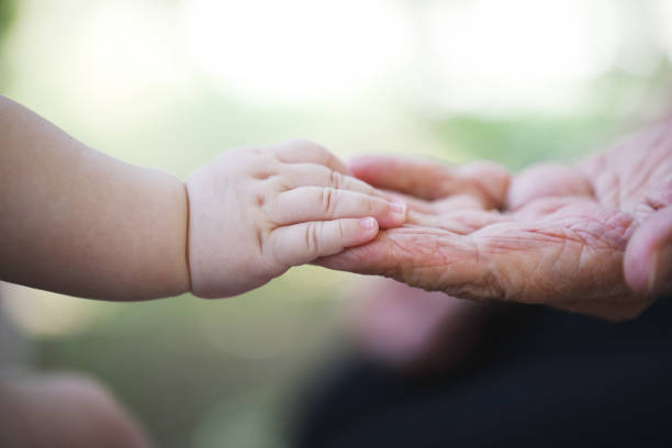 istock Baby hand and grandmother hand 1028204540