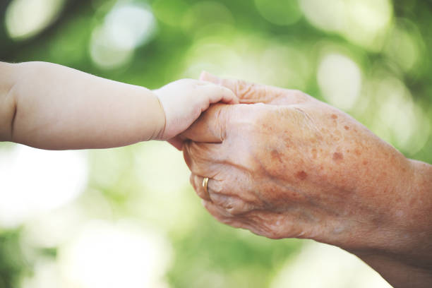 istock Baby hand and grandmother hand 1028207062