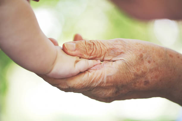 istock Baby hand and grandmother hand 1028208032