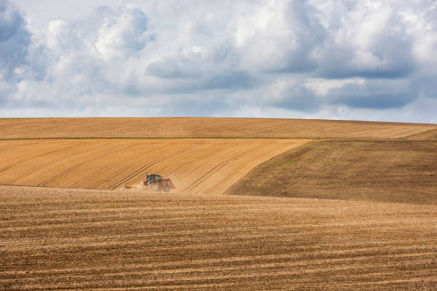 PLERIN, FRANCE -August 07 2018 :Tractor harvester roll straw at Plerin