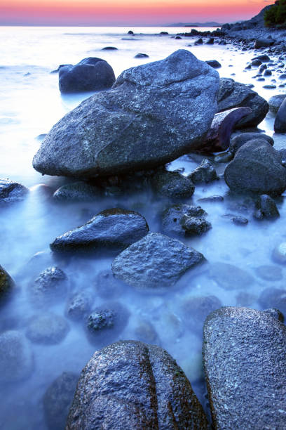 istock Colorful rocky seashore in sunset 1028219950