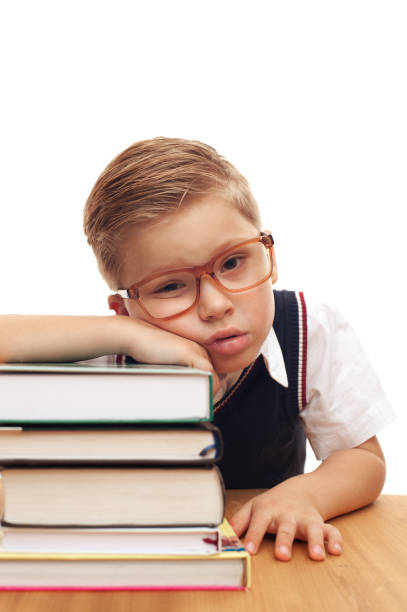 istock Funny cute little boy posing at school desk 1028220154