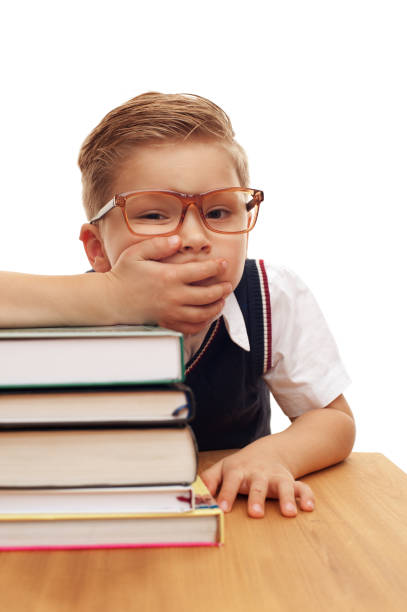 istock Funny cute little boy posing at school desk 1028220204