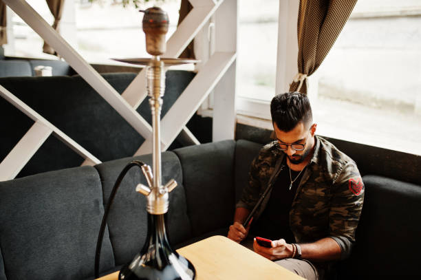 istock Stylish beard arabian man smoke hookah 1028222902