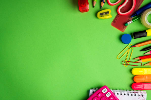 istock green background with a pencils, calculator, ruler and felt-tip pens 1028229148
