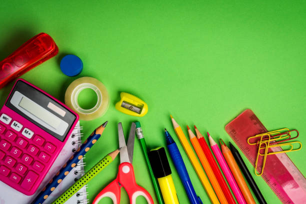 istock green background with a pencils, calculator, ruler and felt-tip pens 1028229262