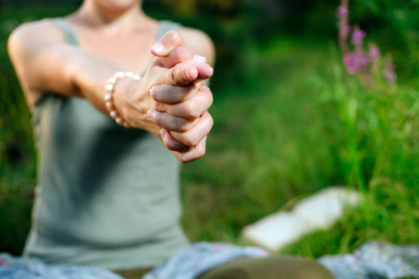 mudra of hand  woman are folded in a special way into a yoga. strongly blurred stock photo