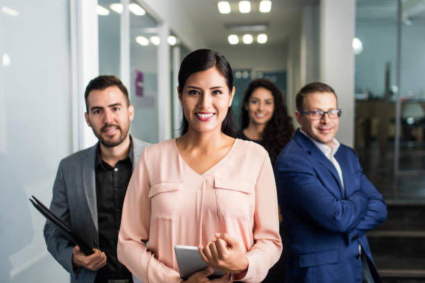 istock Team of executives standing together and smiling 1028234412