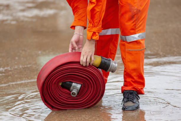 istock Rolled into a roll red fire hose, Fire equipment extinguishers ready to use 1028238178