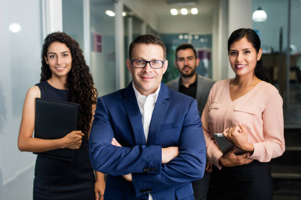 istock Business executives standing and smiling at camera 1028243462
