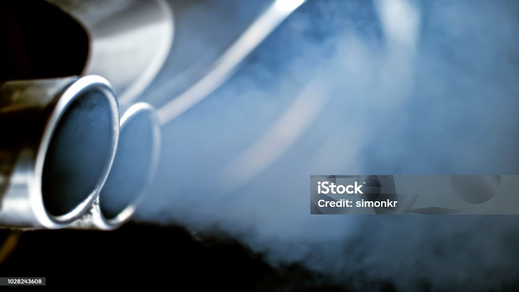 Close-up of car exhaust pipe Smoke emission from exhaust pipe of car. Car Stock Photo