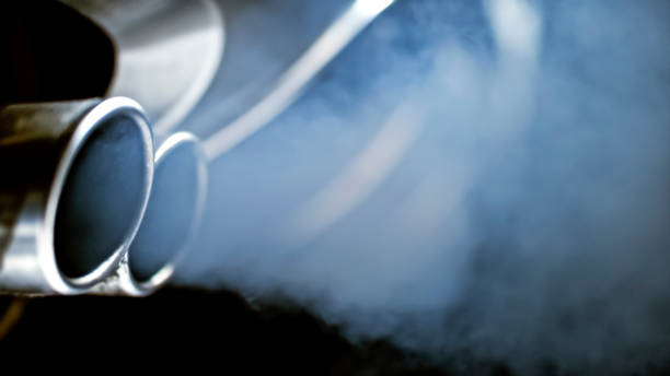 Close-up of car exhaust pipe Smoke emission from exhaust pipe of car. exhaust pipe photos stock pictures, royalty-free photos & images