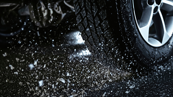 Close-up of water splashing by tyre.