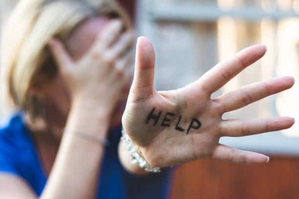 istock Woman gesturing help sign on her hand. 1028249080