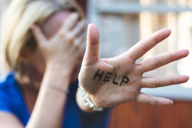 Woman gesturing help sign on her hand. Depression concept victims stock pictures, royalty-free photos & images