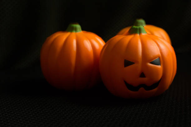 istock The halloween pumpkin jack in black holiday background image. 1028249394