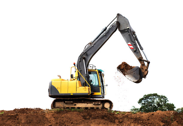 Yellow digger on hill lifting dirt against a white background stock photo