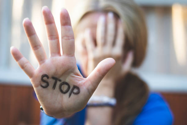 istock Selective focus on open females hand with written stop sign. 1028249908