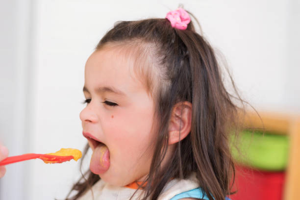 istock Cute little girl eating puree 1028250928