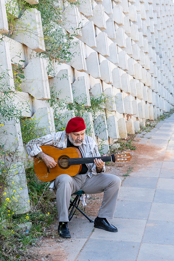 Musician at Outdoor with guitar and He is playing
