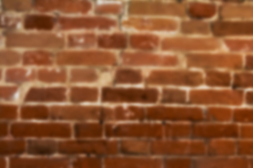 Blurred texture of old brick wall. Rectangular horizontal background with blur.