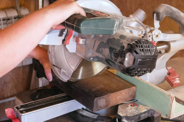 istock Worker sawing a wood board with a circular saw. Close-up hands. 1028259500