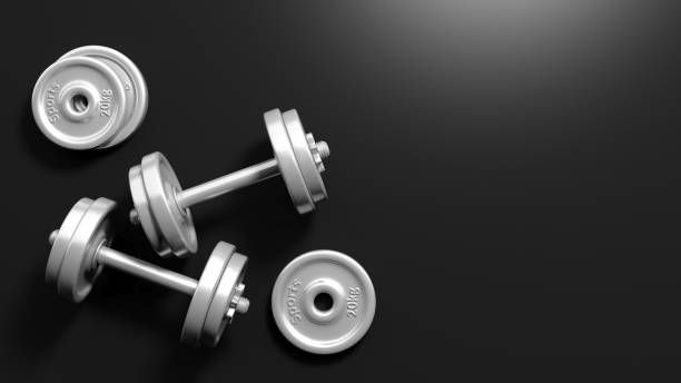 3D rendering of adjustable metallic dumbbells, on black background with copy-space