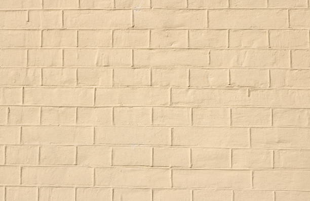 istock faded natural yellow background with brick texture 1028267826