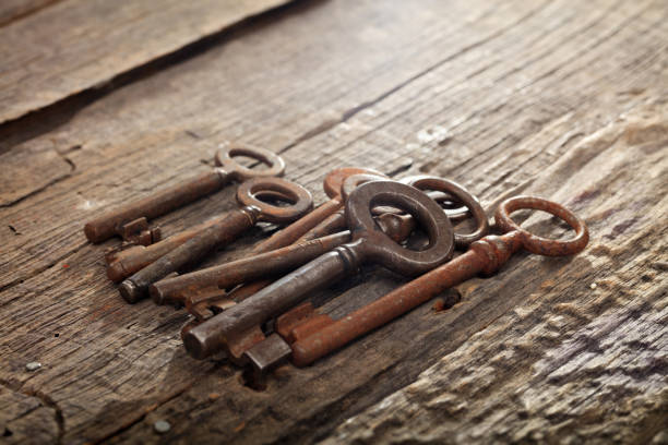 istock Bunch of rusty old keys on wooden surface 1028267830