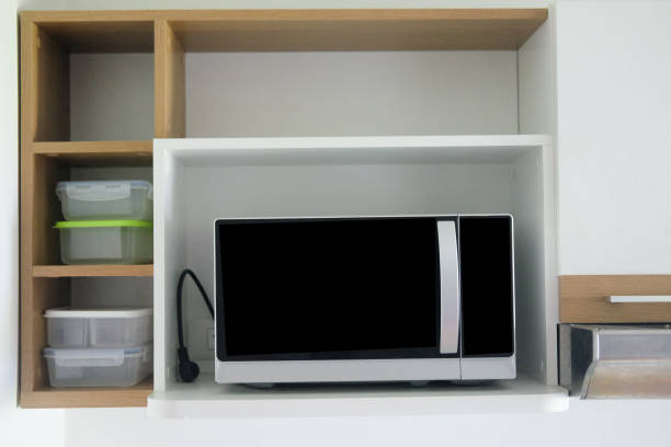 istock Microwave on wooden shelf clean modern kitchen 1028271964