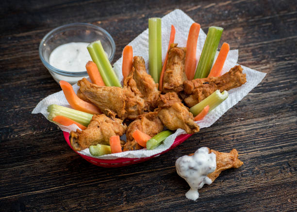 Chicken Wings with Carrots and celery in basket with dip