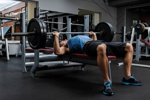 man during bench press exercise - men body building human muscle muscular build imagens e fotografias de stock