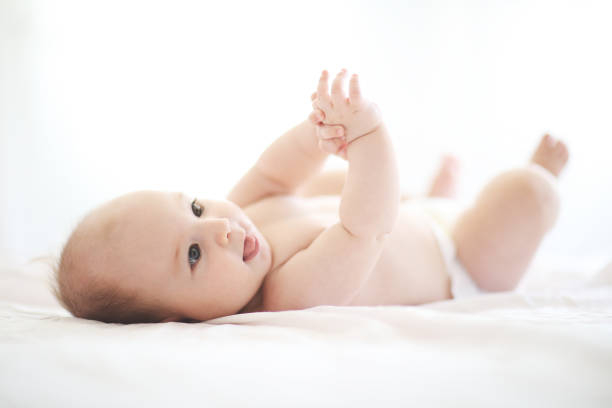 istock Cute adorable baby on bed 1028275414