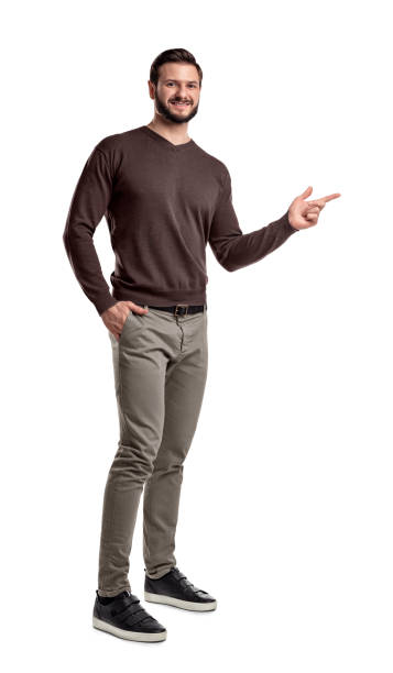 istock A positive young bearded man stands on a white background and point with his finger sideways 1028280638