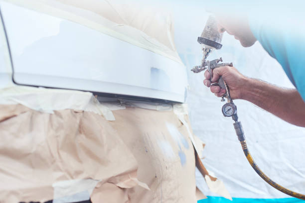 istock Paintwork repair specialist putting colour on coat 1028280644